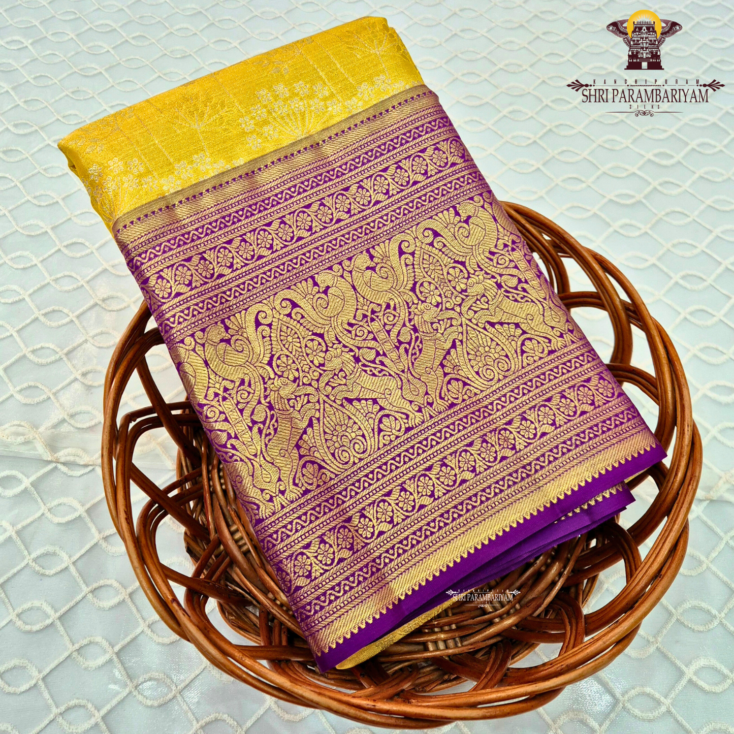 A vibrant sunshine yellow body paired with a rich royal purple border Saree