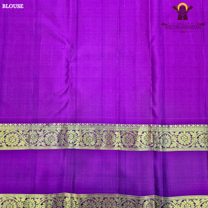 A rich deep violet / royal purple body paired with contrast magenta (pink) and antique gold tones Saree