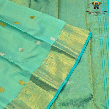 A vibrant mint green body adorned with delicate Saree