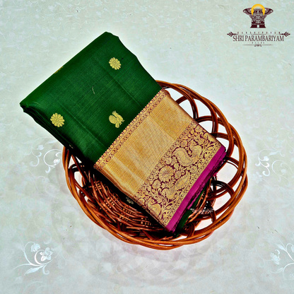 Elegant emerald green body with a rich gold zari Saree