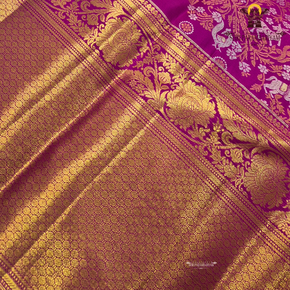 A rich magenta pink body with a contrasting dark green border Saree