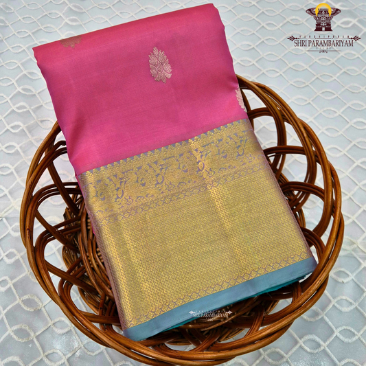 A vibrant rose pink body paired with a rich antique gold zari border Saree