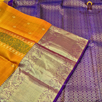A mustard Yellow and Royal Purple with rich Gold Zari weaving Saree