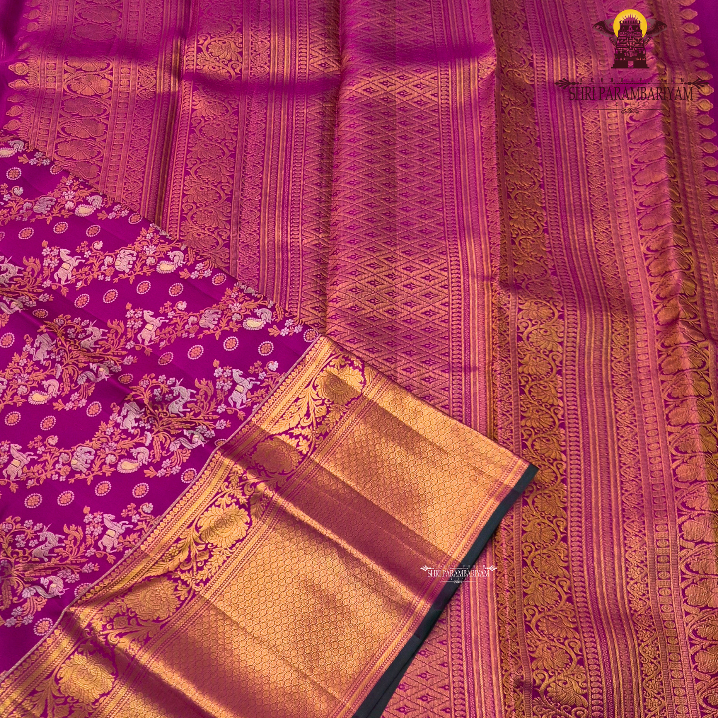 A rich magenta pink body with a contrasting dark green border Saree