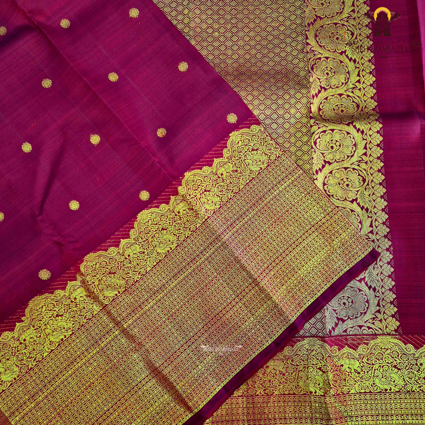 A vibrant ruby red body enhanced with delicate gold zari buttas Saree