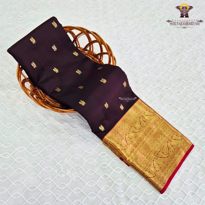 A luxurious deep black grape shade, adorned with delicate gold zari Saree
