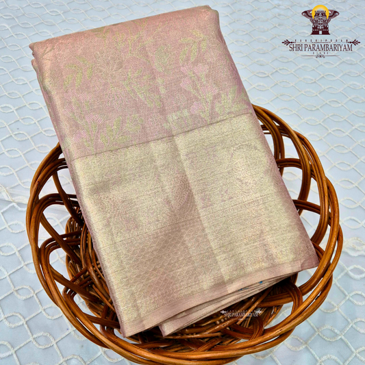 A graceful baby pink shade blended with soft golden tissue Saree