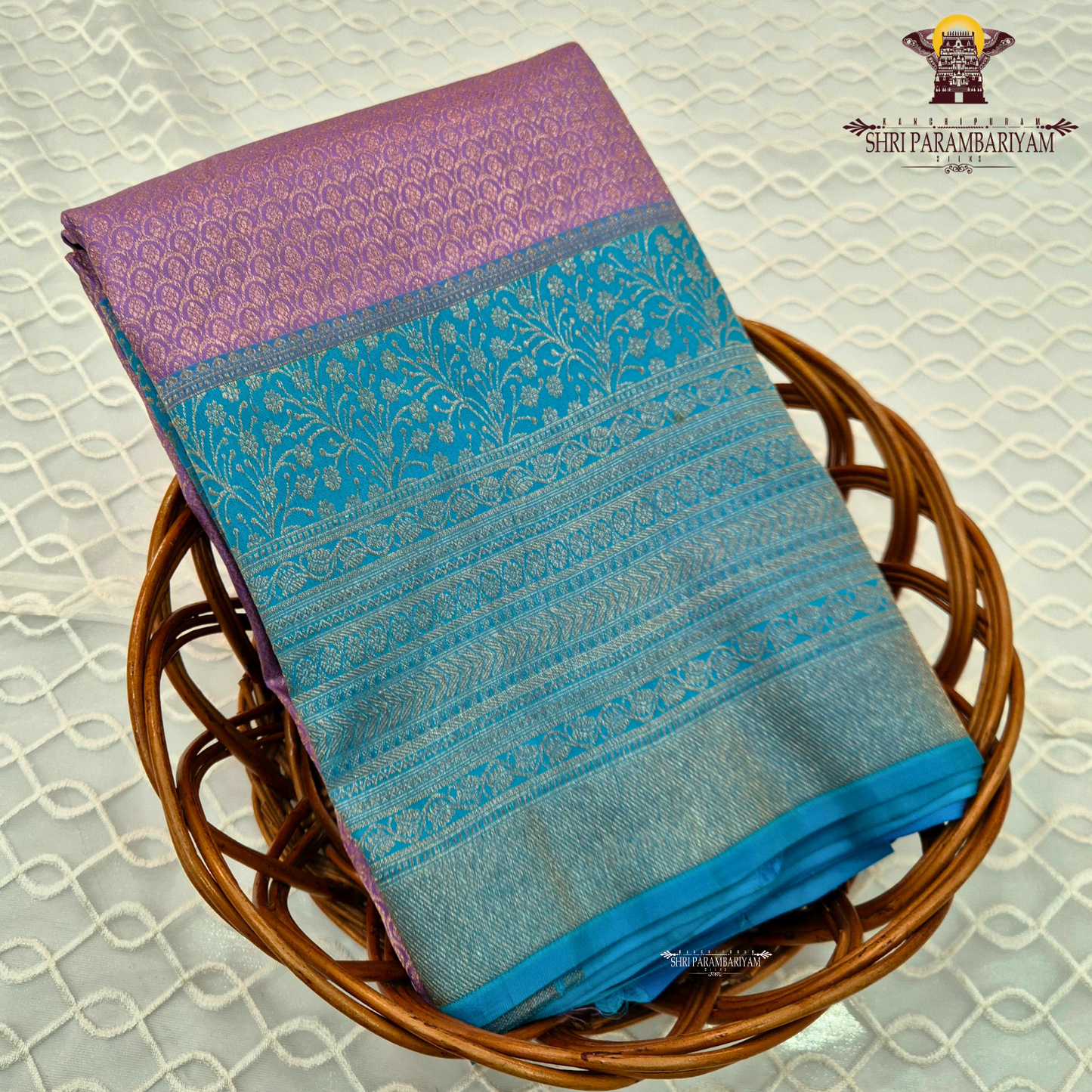 A beautiful combination of lavender (light purple) body with a contrasting turquoise blue (peacock blue) Saree