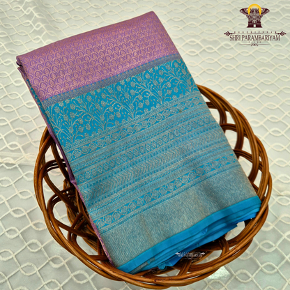 A beautiful combination of lavender (light purple) body with a contrasting turquoise blue (peacock blue) Saree