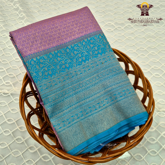 A beautiful combination of lavender (light purple) body with a contrasting turquoise blue (peacock blue) Saree