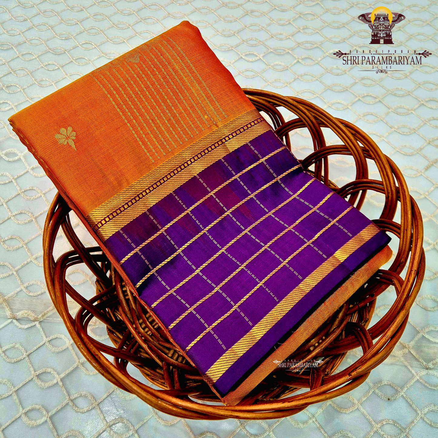 A rich mustard orange body paired beautifully with a deep royal purple pallu and border Saree