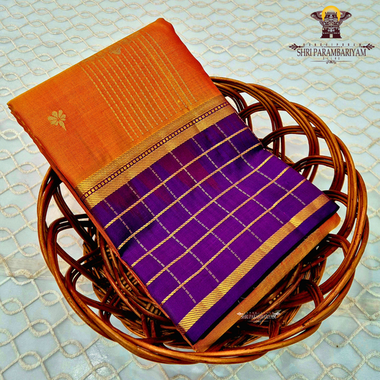 A rich mustard orange body paired beautifully with a deep royal purple pallu and border Saree