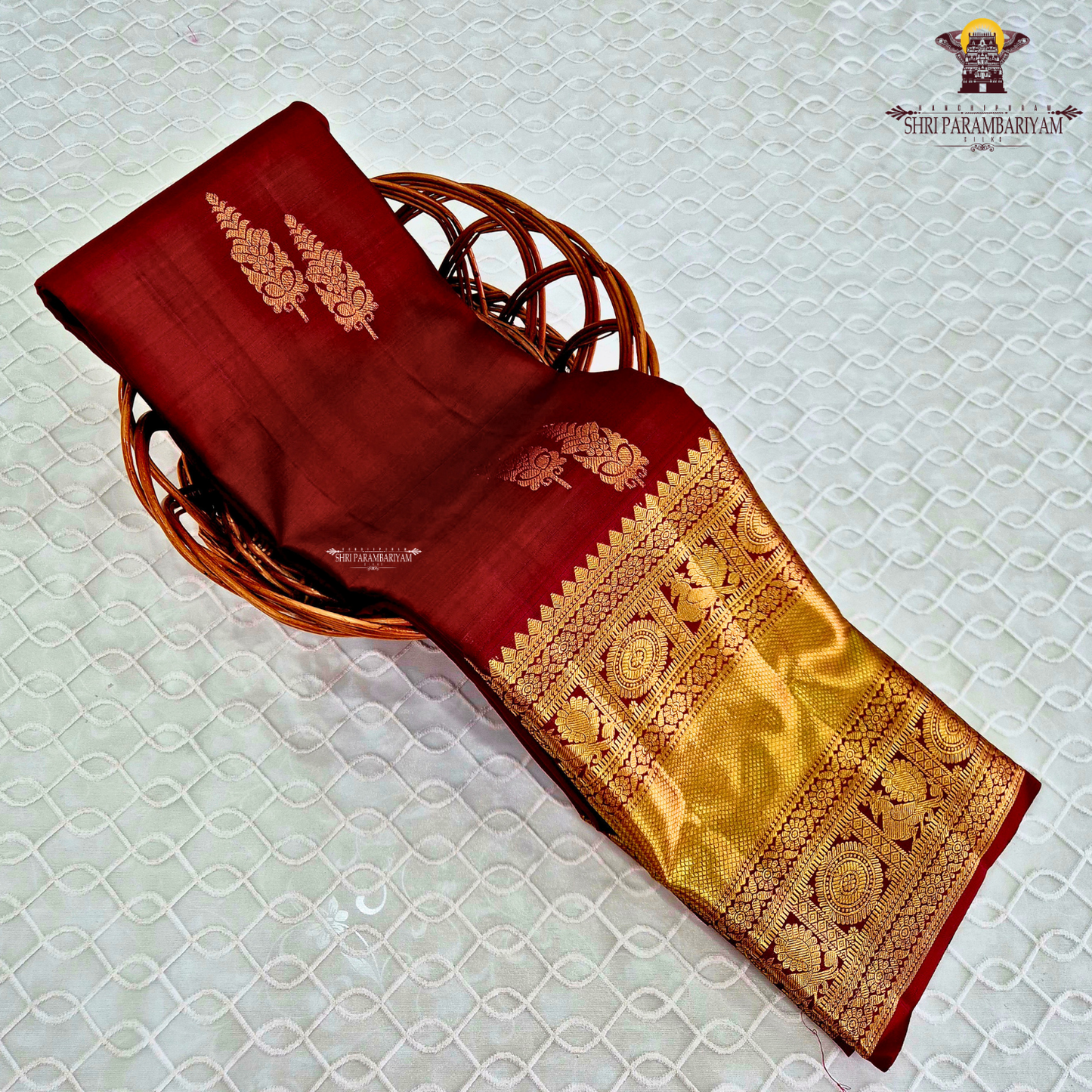 A rich maroon shade, beautifully adorned with elegant gold zari Saree
