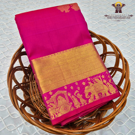 A bright Rani Pink with rich Gold zari Saree