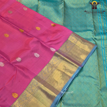 A vibrant rose pink body paired with a rich antique gold zari border Saree