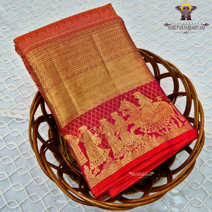 A vibrant bridal red color paired with rich gold zari weaving Saree