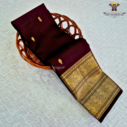 An elegant Deep Wine Maroon shade, beautifully enhanced with delicate gold zari Saree