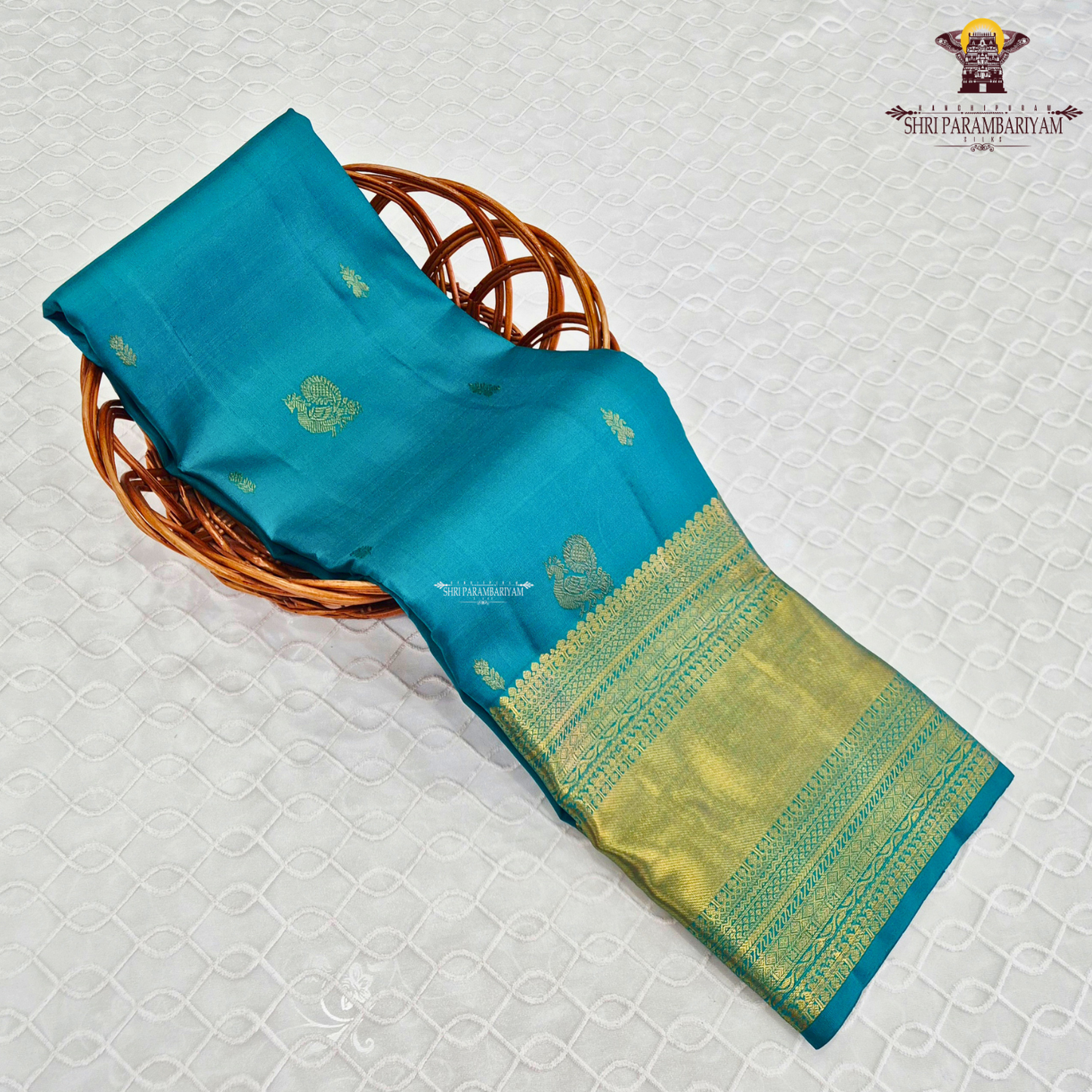 A elegant Peacock Blue (a vibrant blend of teal blue with a hint of turquoise) Saree