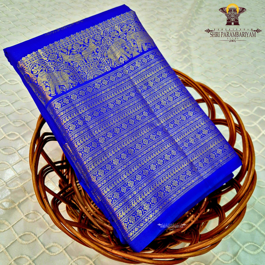 A vibrant Royal Blue with Antique Gold Zari Saree