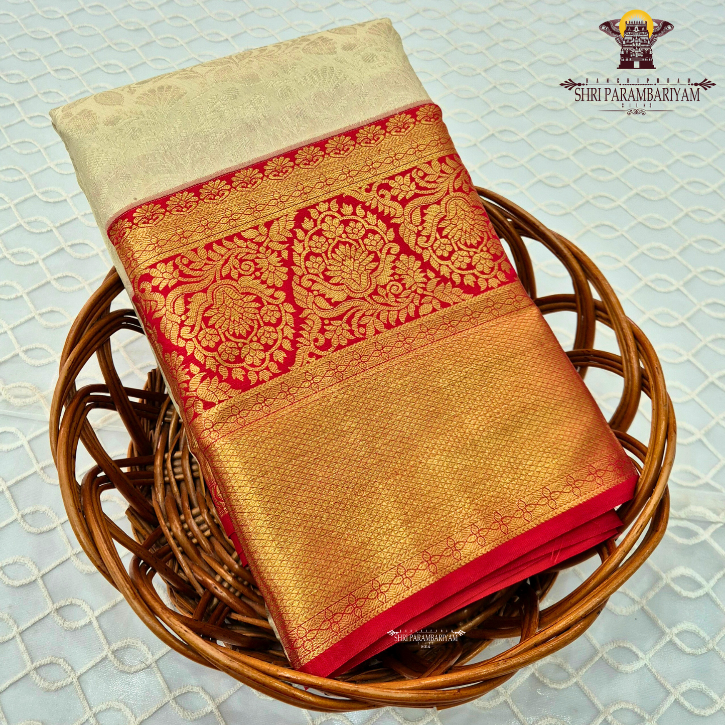 Soft cream/ivory body paired with a striking deep red border Saree
