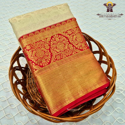 Soft cream/ivory body paired with a striking deep red border Saree