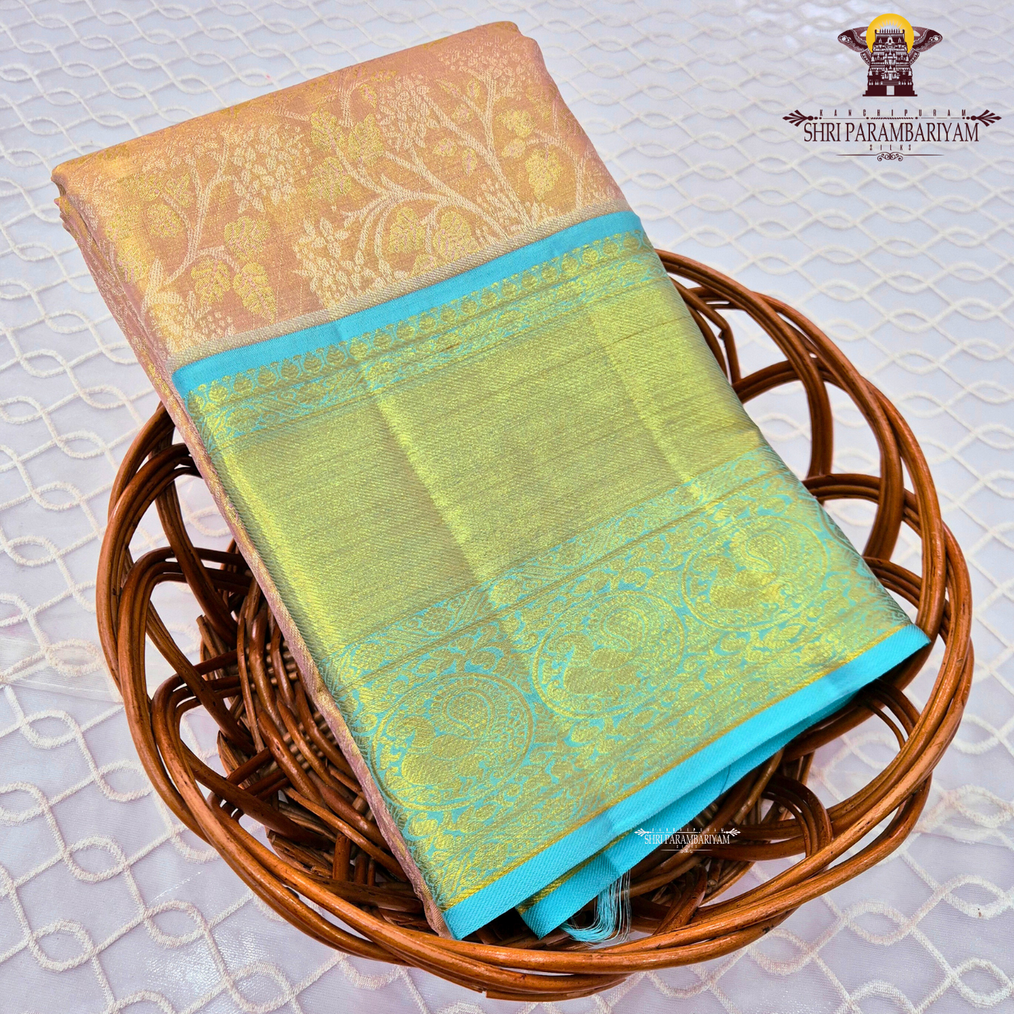 A soft peach / blush pink body paired with a contrasting aqua blue border Saree