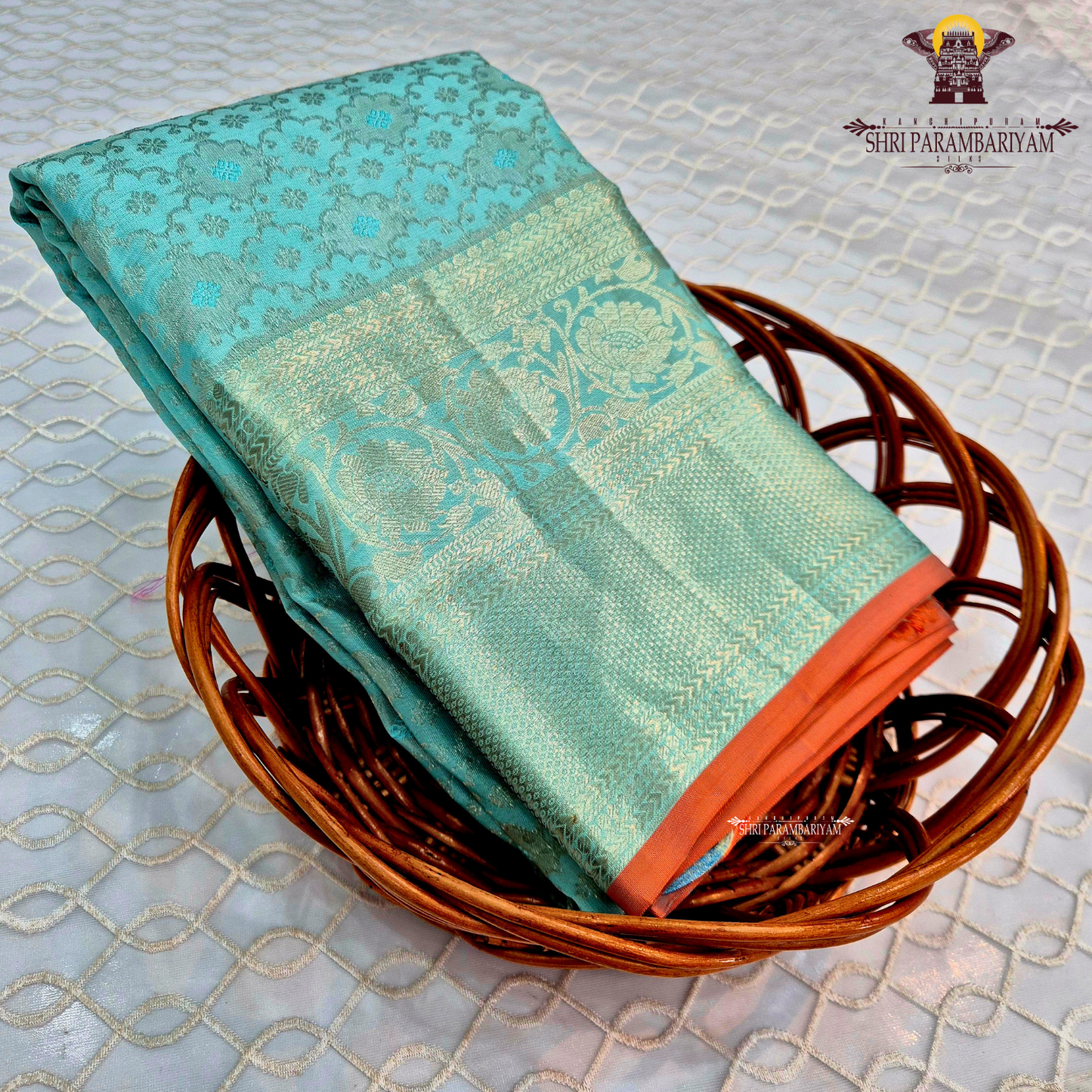 Elegant sea green / aqua blue shade with silver zari work and a subtle peach Saree