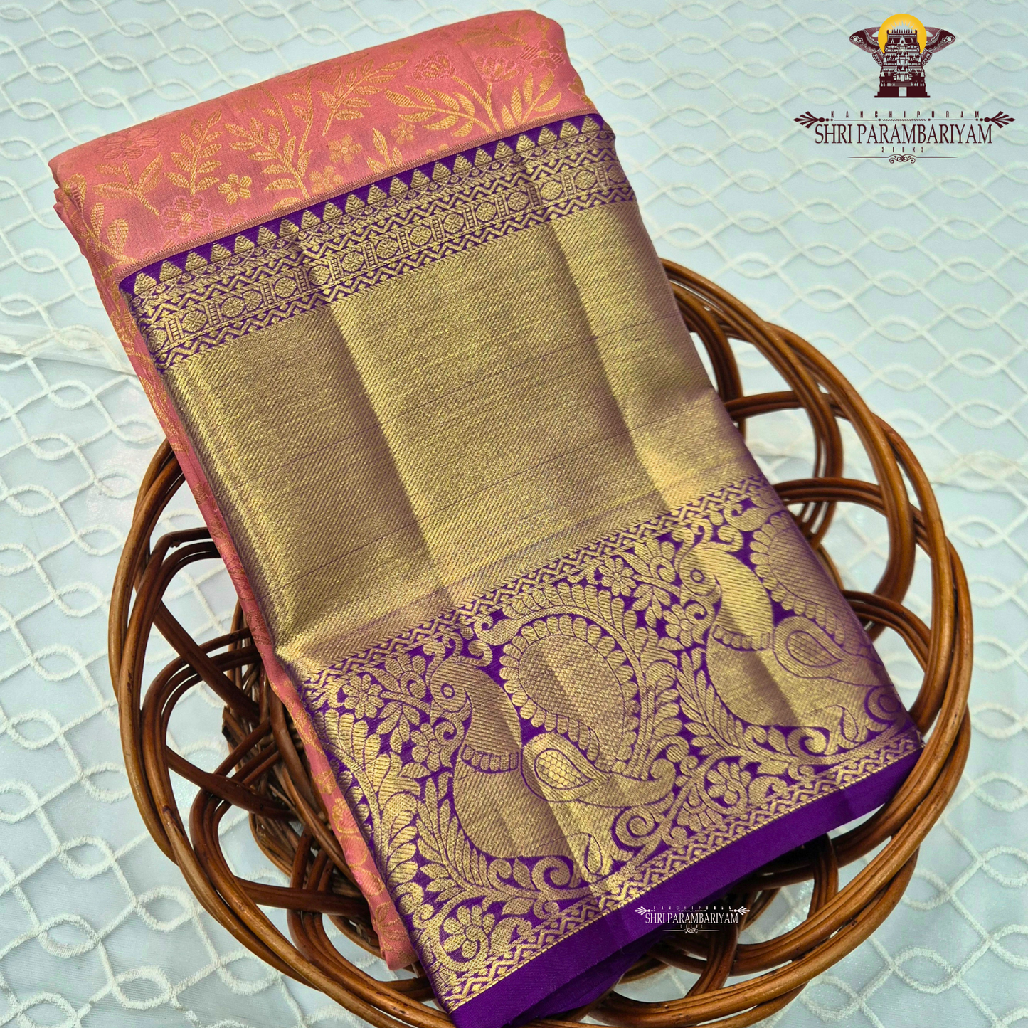 A soft peach pink body paired with a rich royal purple korvai border Saree
