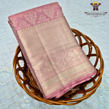 A charming soft baby pink shade beautifully blended with shimmering gold tissue Saree