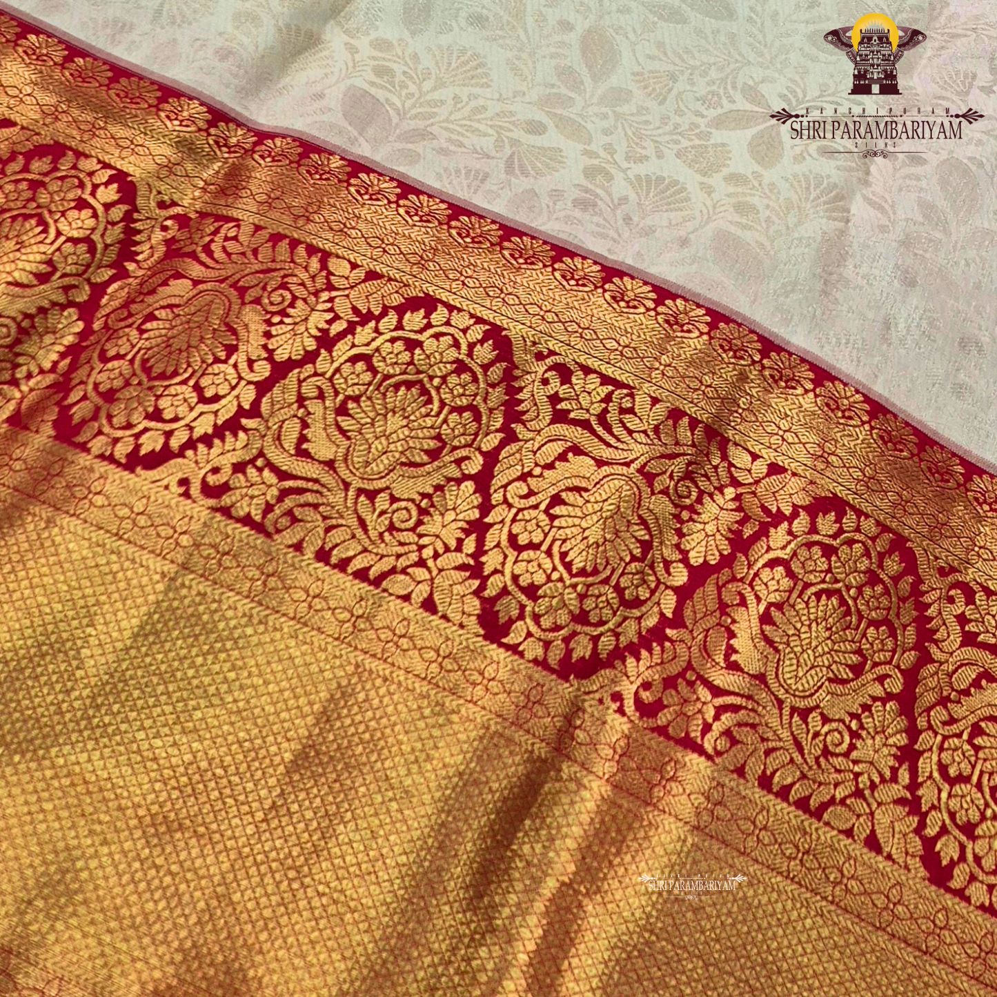 Soft cream/ivory body paired with a striking deep red border Saree