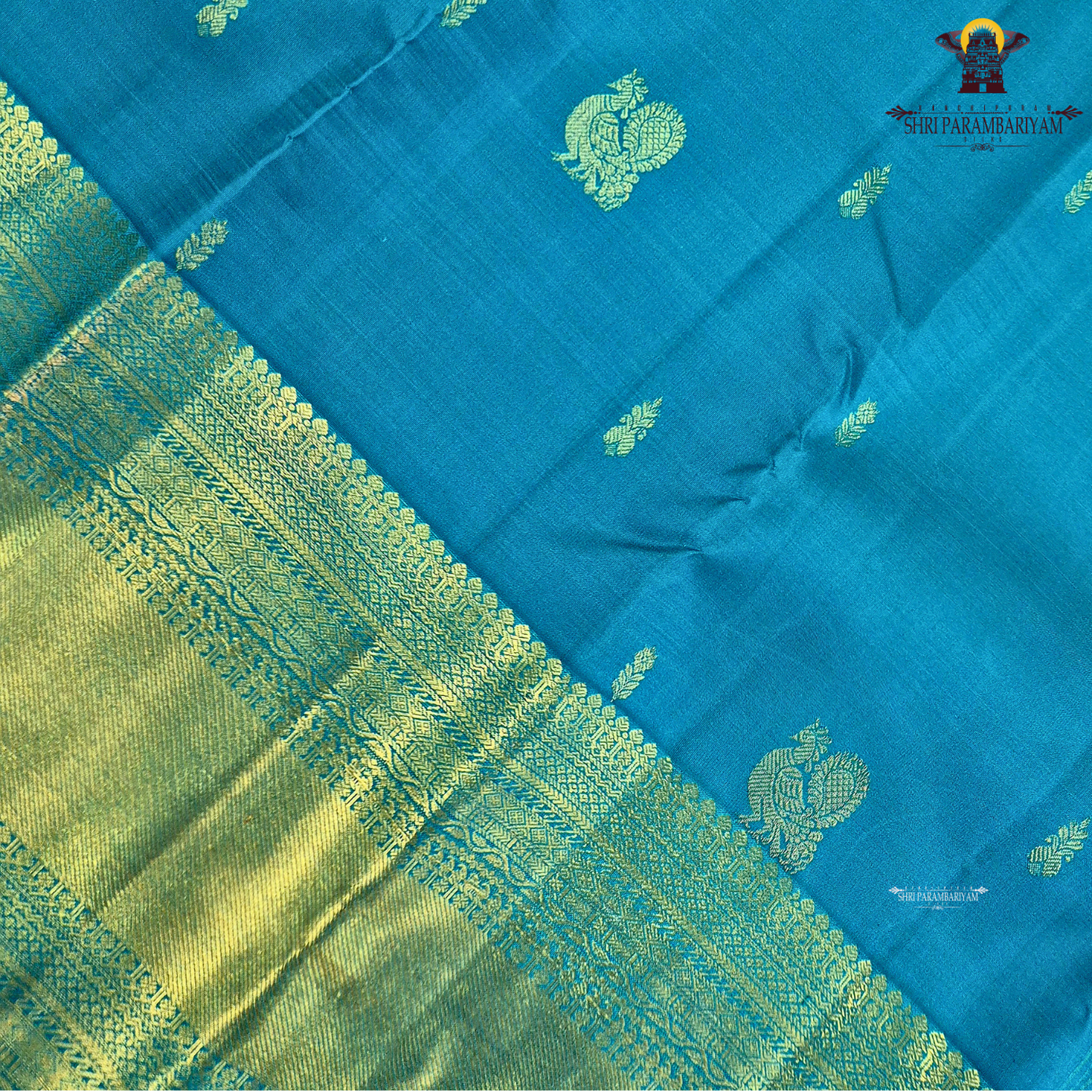 A elegant Peacock Blue (a vibrant blend of teal blue with a hint of turquoise) Saree
