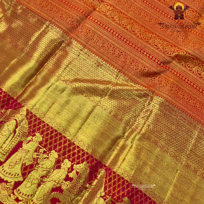 A vibrant bridal red color paired with rich gold zari weaving Saree