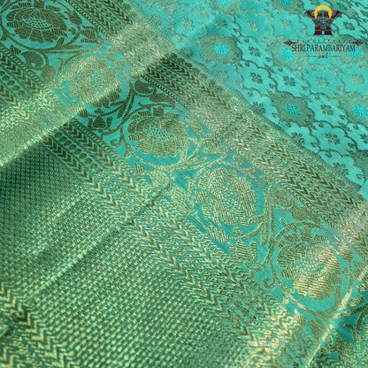 Elegant sea green / aqua blue shade with silver zari work and a subtle peach Saree