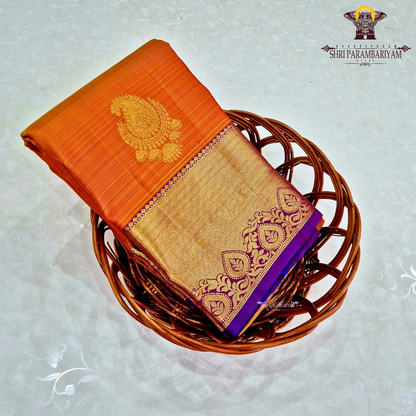 A rich Bright mango orange body with a rich gold zari Saree