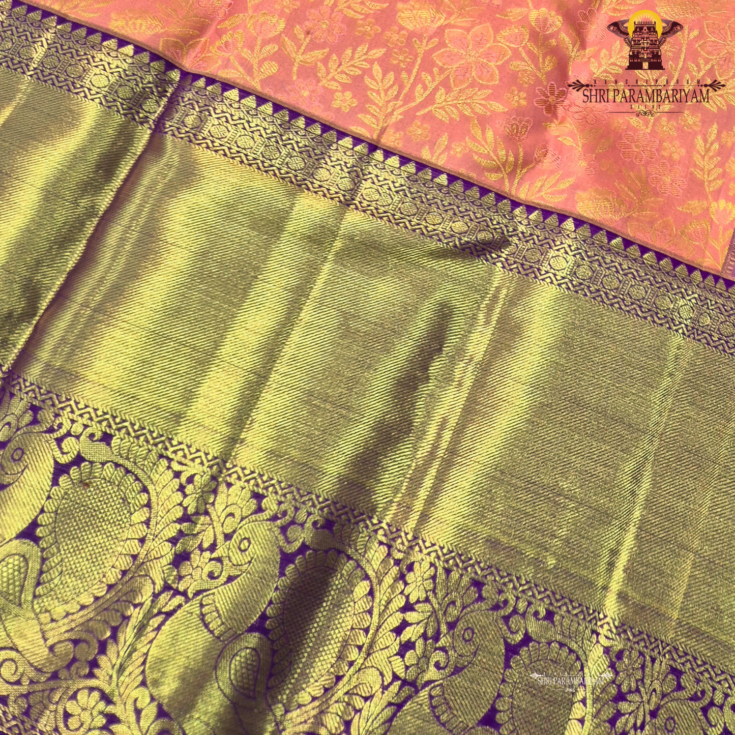 A soft peach pink body paired with a rich royal purple korvai border Saree
