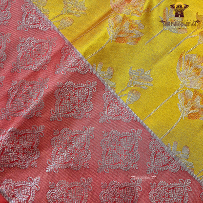 Mustard yellow body with coral pink / peach contrast pallu and elegant silver zari work Saree