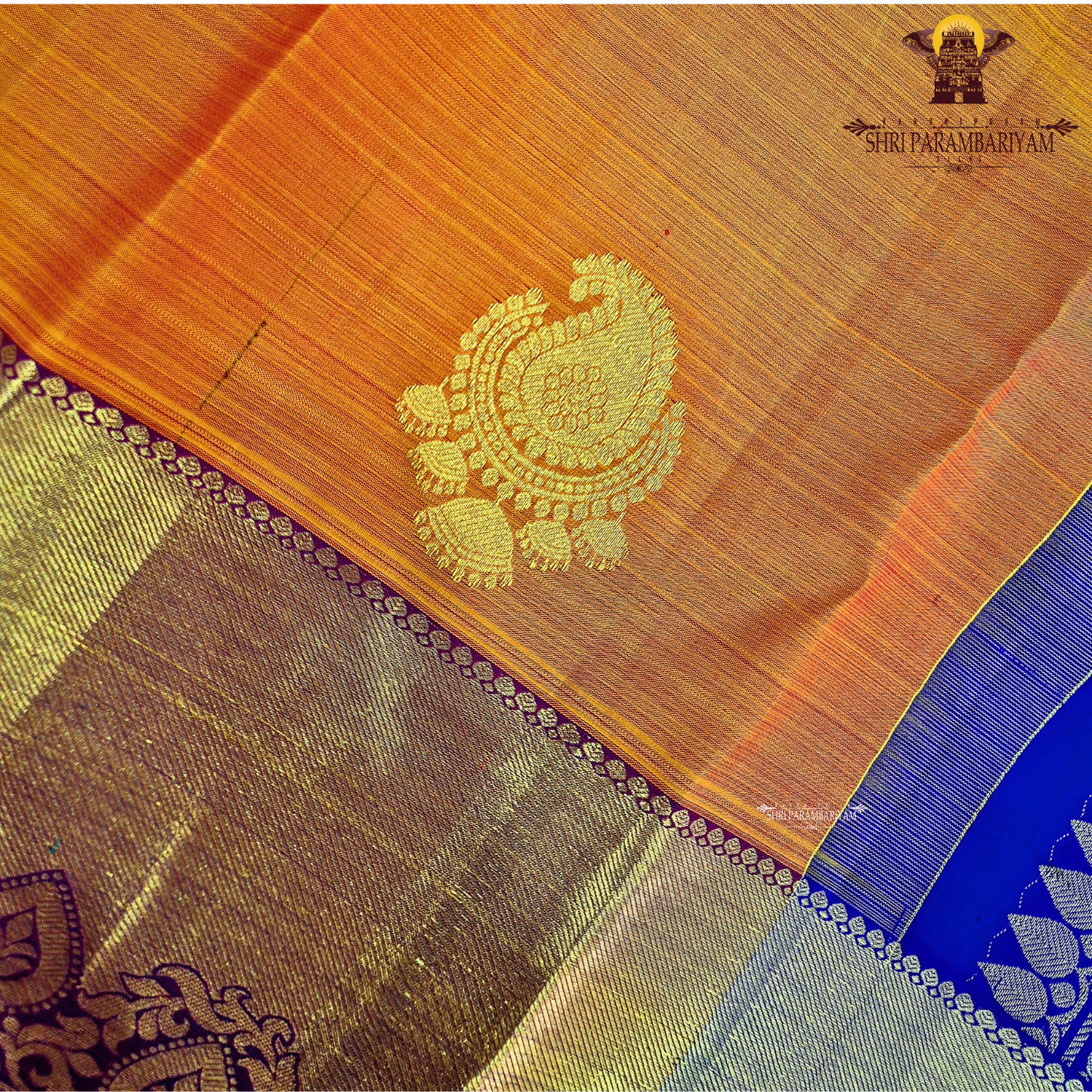 A rich Bright mango orange body with a rich gold zari Saree