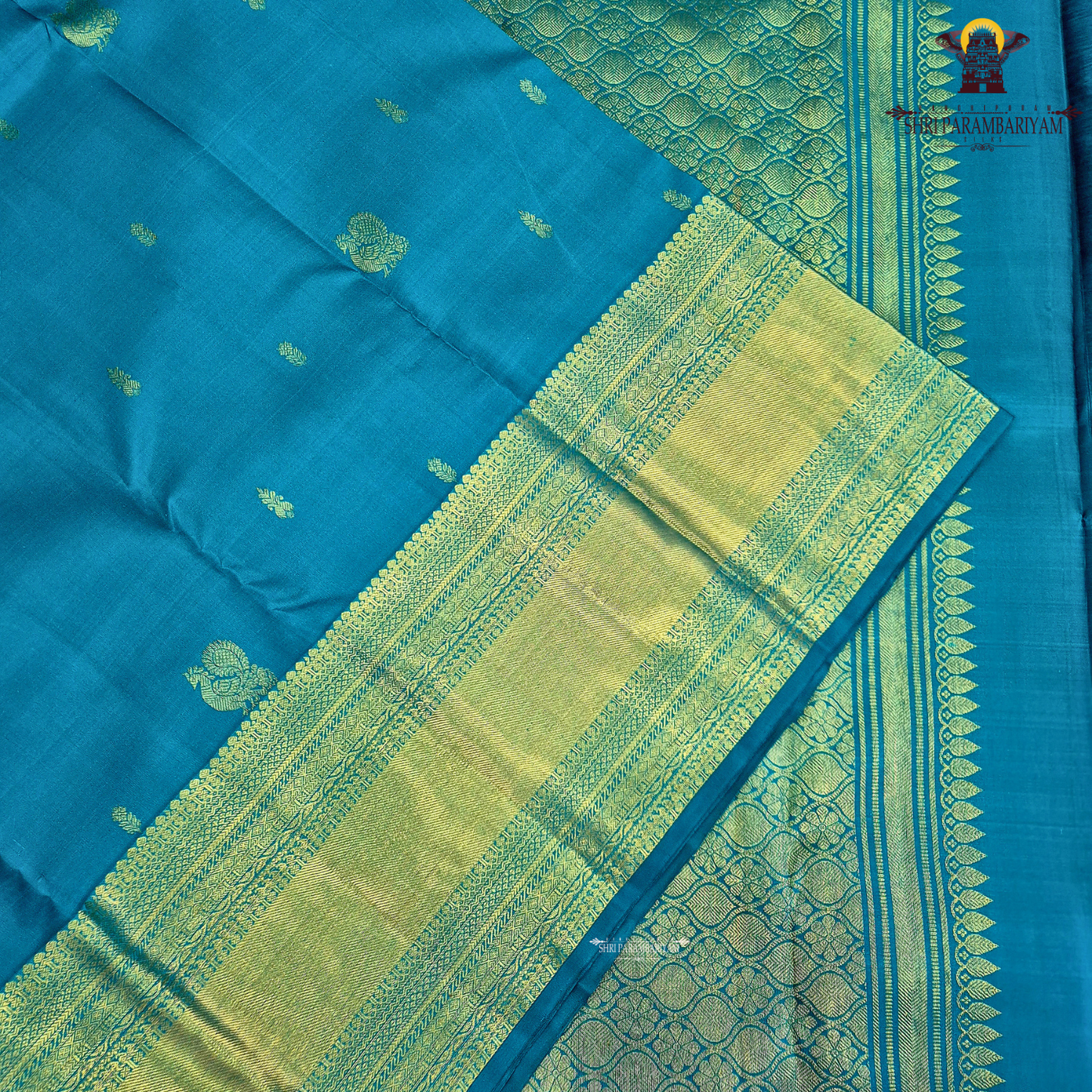 A elegant Peacock Blue (a vibrant blend of teal blue with a hint of turquoise) Saree