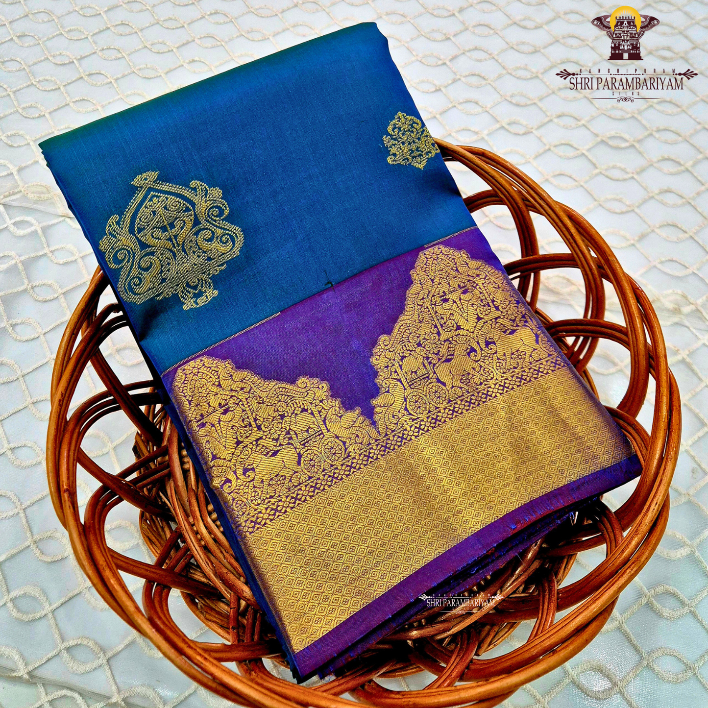 Elegant teal blue body with rich royal purple contrast pallu and antique gold zari Saree