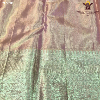 A rich antique gold tissue base blended with pastel mint green and soft peach tones Saree