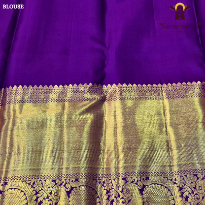 A soft peach pink body paired with a rich royal purple korvai border Saree