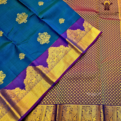 Elegant teal blue body with rich royal purple contrast pallu and antique gold zari Saree