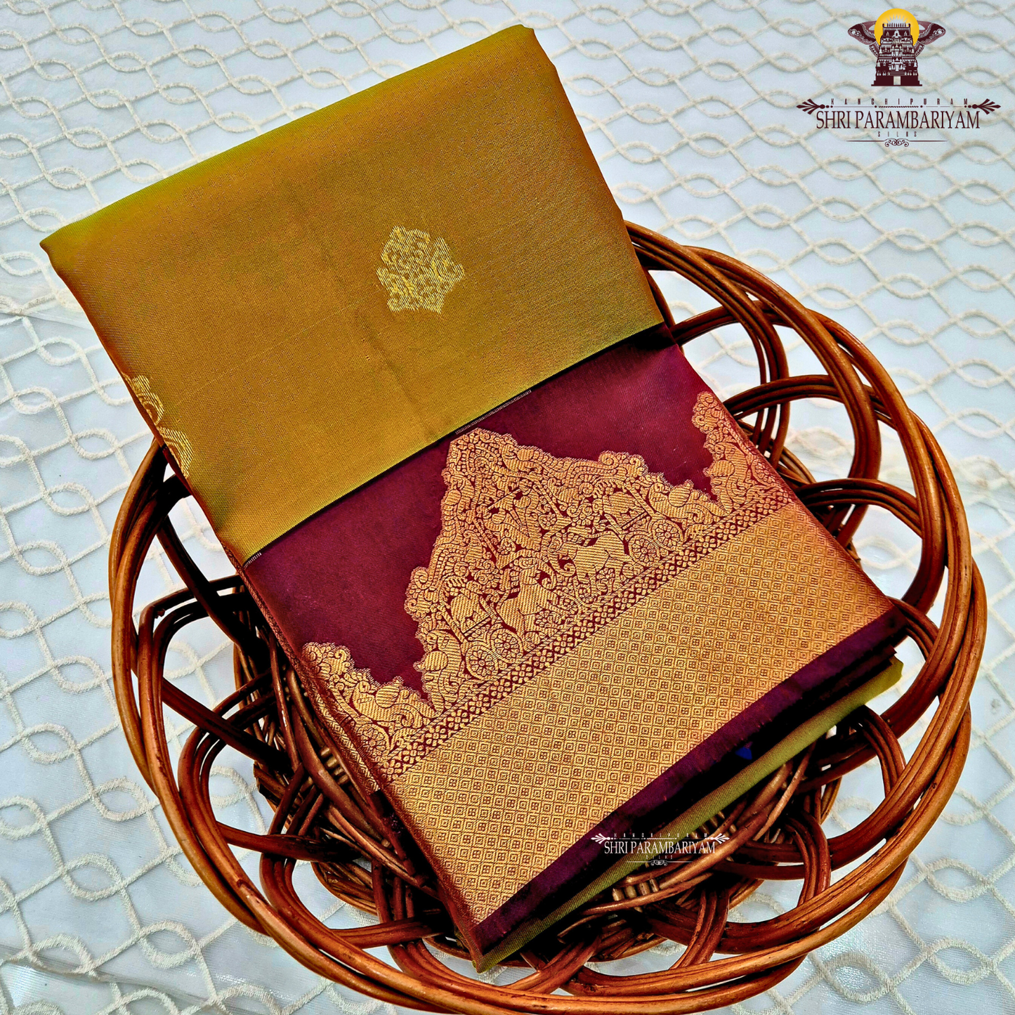 Rich mustard-gold body with deep maroon contrast pallu and antique gold zari Saree