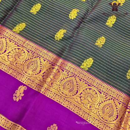 Deep bottle green body with rich royal purple contrast pallu and antique gold zari Saree