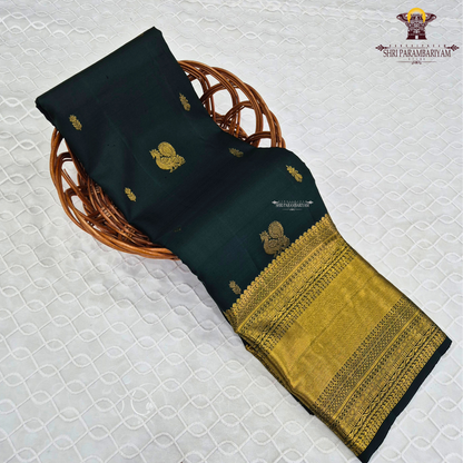A captivating Deep Bottle Green / Dark Teal Green shade, beautifully complemented Saree