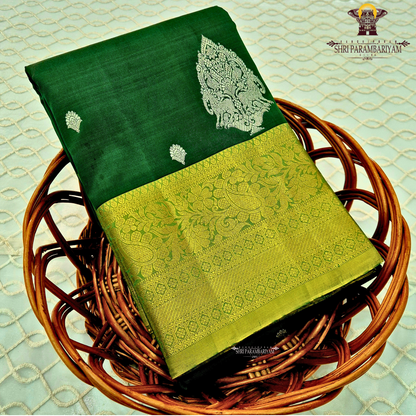 Rich bottle green with a contrasting antique gold zari border featuring a subtle olive-green tone Saree