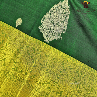 Rich bottle green with a contrasting antique gold zari border featuring a subtle olive-green tone Saree