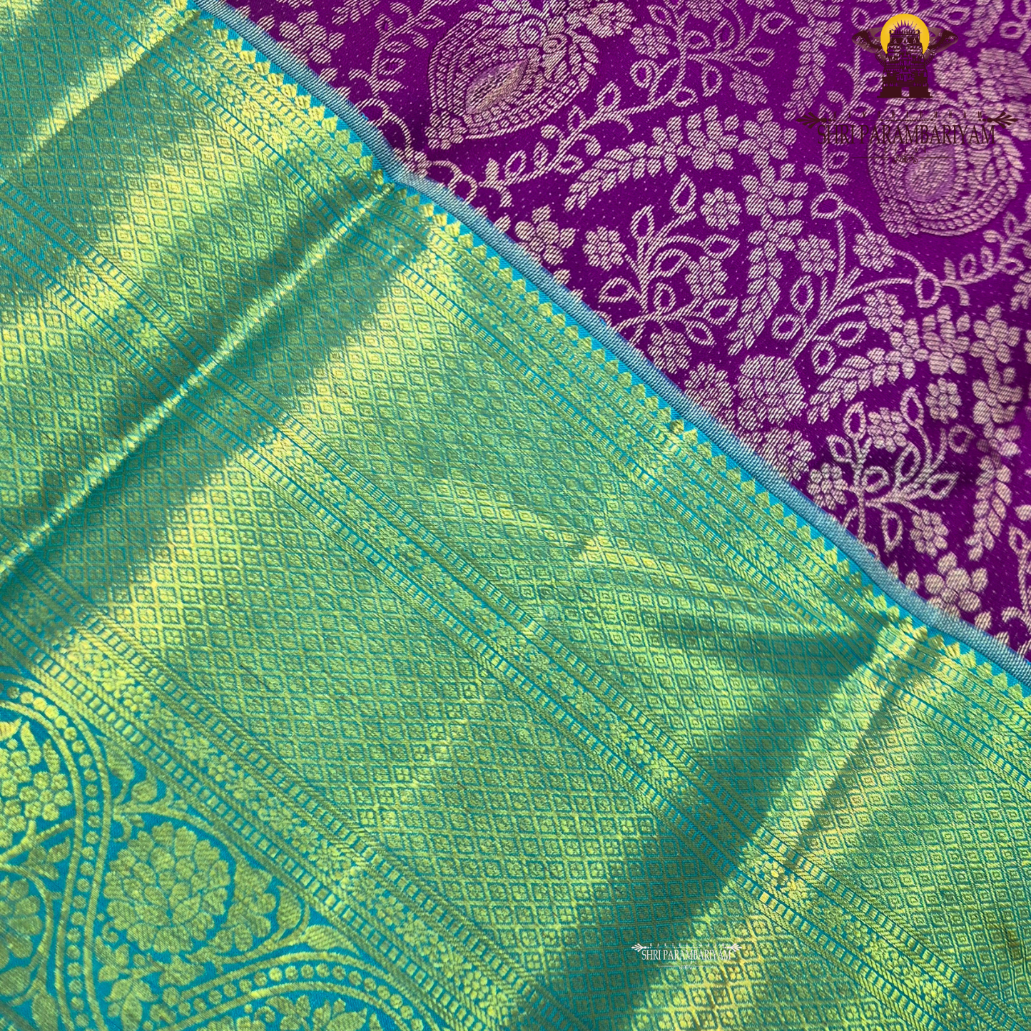 A rich violet purple body with a contrasting sky blue korvai border Saree