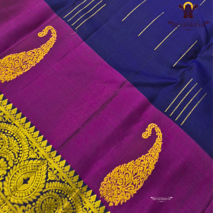 A rich royal blue body beautifully contrasted with a vibrant magenta Saree