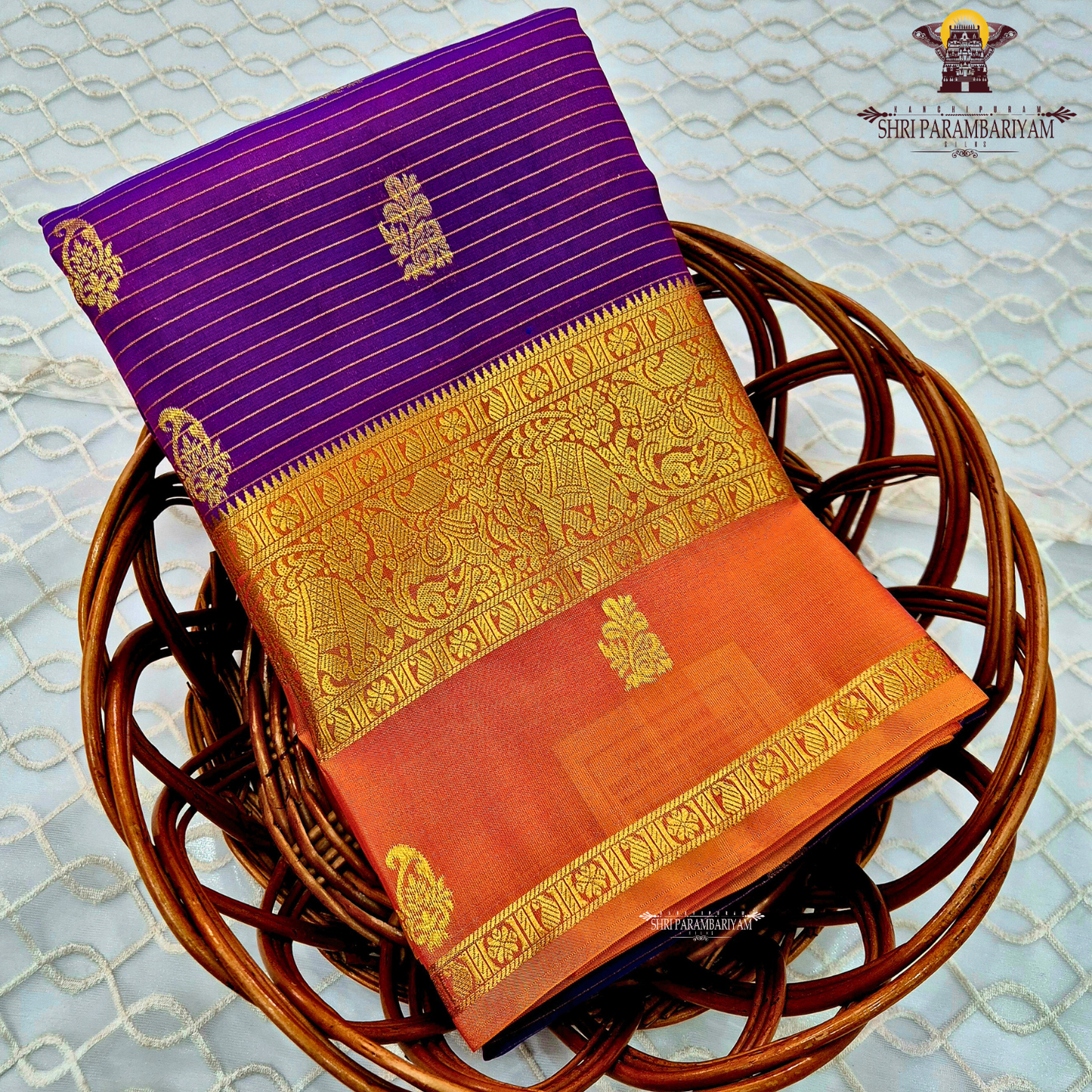 Deep royal purple body with rust orange contrast pallu and rich antique gold zari Saree